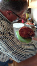 Bob carves the ham.