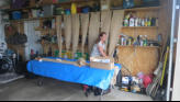 Sue attempting to cover up garage shelves