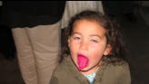 Nora shows her red frosting tongue.