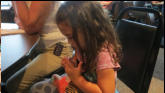 Cleaning her nails.
