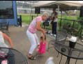 Great Grandma and Nora dance a jig.