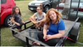 Nora, Elaina and Kris supervising trailer light installation.