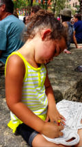 Nora takes time out to color picture.