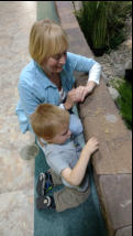 Janet and Nancy's grandson feeding fish.