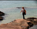 Sue trecking on the shoreline.