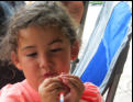 Nora plays with an inch worm.