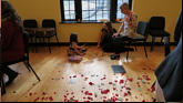 Nora, Nicole and Great Grandma work on dinosaur puzzle.