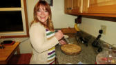 Kris cutting the delicious apple pie she made.
