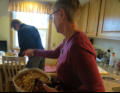 Arlene pulls a casserole from the oven.