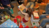 Nora first to open gifts.