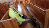 Arlene showing off foot warmers in pews.